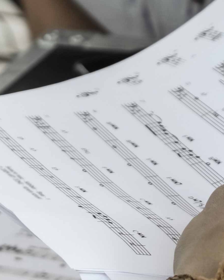 A person holding music sheets
